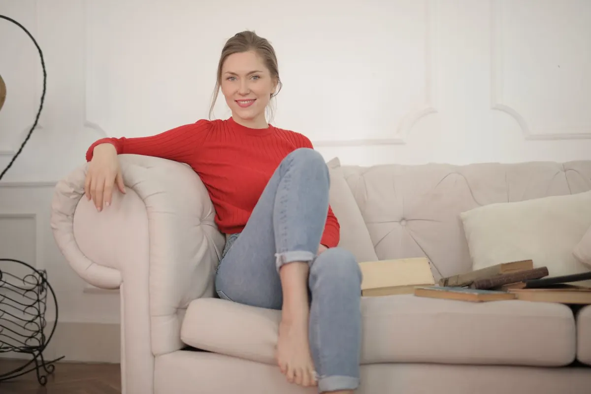 A woman in her forties relaxing on a sofa at home