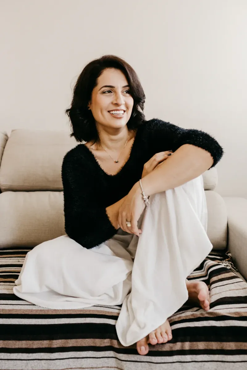 A woman sitting comfortably at home, looking at ease